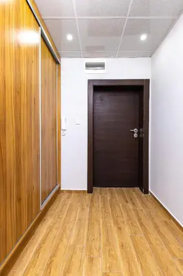 an office hallway with a door and wooden floors at Bright and Cozy Apartment Next to a City Park by Flat Mаnager in Plovdiv