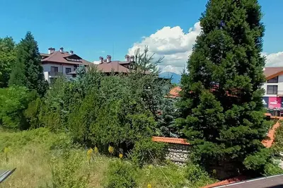 a view of a yard with trees and houses at Friendly apartment -top location in Bansko
