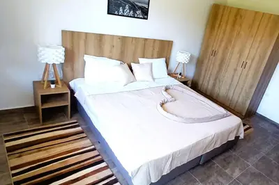 a bedroom with a large bed with white sheets and pillows at Friendly apartment -top location in Bansko