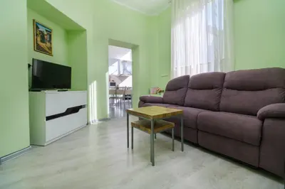a living room with a couch and a table at 1-bedroom City Center secret gem in Plovdiv