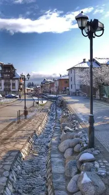 a street light next to a cobblestone street at Belvedere Holiday Club H80 in Bansko