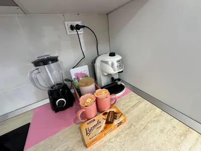 a kitchen counter with two cups and a blender at Central Art Studio in Sofia