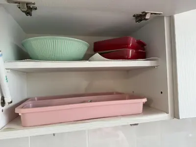a shelf with bowls and a pink box in a kitchen at Central Art Studio in Sofia