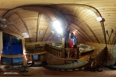 a man standing in a room in a wooden room at Ski liviomoritz at gma il com Chalet in Madzhare