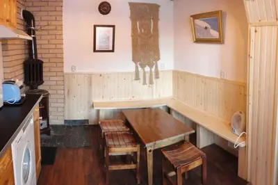 a kitchen with a wooden bench and a clock on the wall at Ski liviomoritz at gma il com Chalet in Madzhare