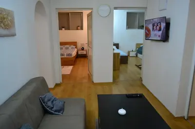 a living room with a couch and a table at TOP Center, basement fl, 7 beds, 10min from Serdica in Sofia