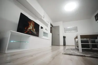 a white living room with a tv on a wall at The Secret Paradise in Sofia