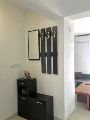 a room with a dresser and a mirror on a wall at Апартамент Пирин in Sandanski
