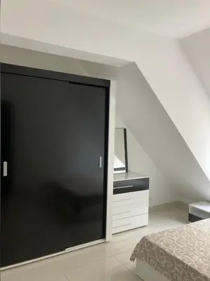 a bedroom with a large sliding glass door next to a bed at Апартамент Пирин in Sandanski