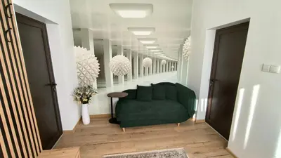 a living room with a green couch in a hallway at Къща за гости Етерна - Guest house Eterna in Starosel