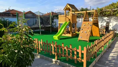 a playground with a slide and a climbing frame at Къща за гости Етерна - Guest house Eterna in Starosel