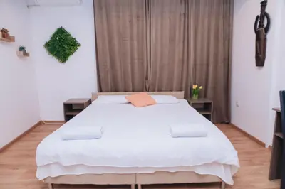 a bedroom with a large white bed in it at BASSO Guest Rooms in Perushtitsa