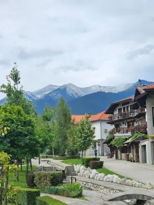a street in a town with mountains in the background at Ski In Out Aparthotel Kosara in Bansko
