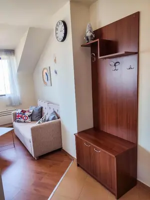 a living room with a large wooden cabinet and a couch at 