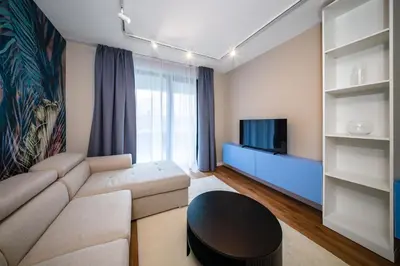 a living room with a couch and a tv at Aviva Living by Flat Mаnager in Sofia
