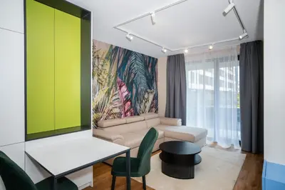 a living room with a couch and a table at Aviva Living by Flat Mаnager in Sofia