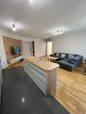 a large living room with a couch and a table at FREESIA apartment with underground parking in Sofia