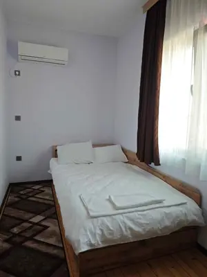 a bed in a room with a large window at Къща за гости Савана, Пловдив,Plovdiv, летище Пловдив, Plovdiv Airport,Ягодово in Yagodovo