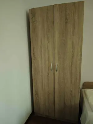 a wooden cabinet in the corner of a bedroom at Къща за гости Савана, Пловдив,Plovdiv, летище Пловдив, Plovdiv Airport,Ягодово in Yagodovo