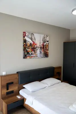 a bedroom with a bed and a painting on the wall at AveNew Luxury Apartment 3 in Sofia