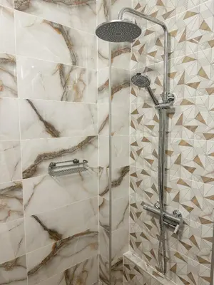 a bathroom with a shower with a glass door at Bibi Central Apartment Plovdiv in Plovdiv