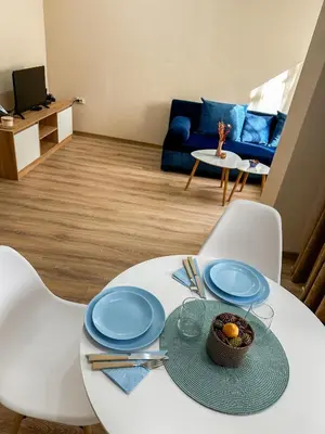 a white table with a bowl of fruit on it at Bibi Central Apartment Plovdiv in Plovdiv