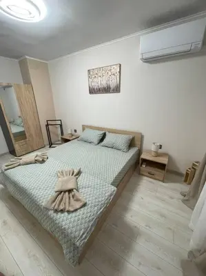 a bedroom with a bed with a dress on it at Apartment Iztochen blvd, free parking in Plovdiv