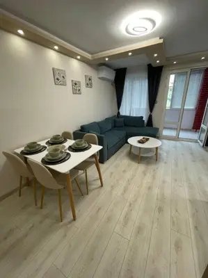 a living room with a couch and a table at Apartment Iztochen blvd, free parking in Plovdiv