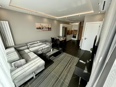 a living room with a white couch and a table at AveNew Luxury Apartment 2 in Sofia