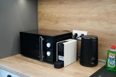 a microwave oven sitting on top of a counter at AveNew Luxury Apartment 2 in Sofia