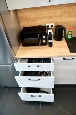 a kitchen counter with white drawers and a coffee maker at AveNew Luxury Apartment 2 in Sofia