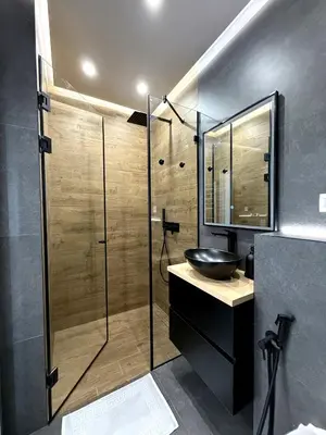 a bathroom with a sink and a glass shower at AveNew Luxury Apartment 2 in Sofia