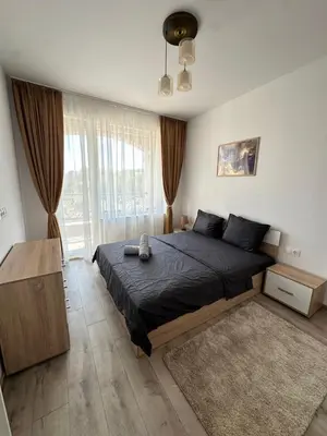 a bedroom with a bed and a large window at 1BD Flat near Maritsa river and City Center in Plovdiv