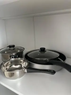 two pots and pans sitting on top of a stove at 1BD Flat near Maritsa river and City Center in Plovdiv