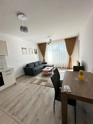 a living room with a table and a couch at 1BD Flat near Maritsa river and City Center in Plovdiv