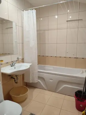 a bathroom with a sink and a tub and a toilet at ТОП Локация и УЮТ in Bansko