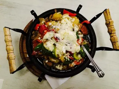 a pan filled with food on top of a stove at ТОП Локация и УЮТ in Bansko