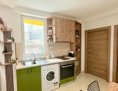 a kitchen with a sink and a washing machine at Center Apartments The Quiet Luxury 1 in Plovdiv
