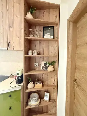 a wooden shelf in a kitchen with dishes on it at Center Apartments The Quiet Luxury 1 in Plovdiv