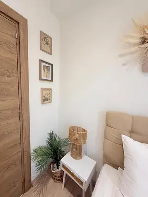 a bedroom with a bed and a table with a lamp at Center Apartments The Quiet Luxury 1 in Plovdiv