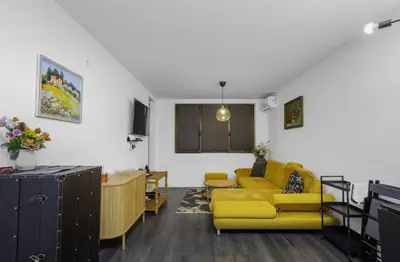 a living room with a yellow couch and a table at Cozy 1BD Flat Close to the City Center by Flat Mаnager in Sofia