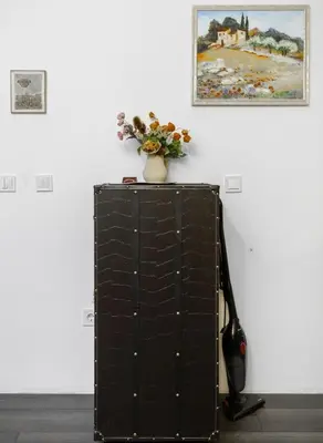 a vase of flowers sitting on top of a cabinet at Cozy 1BD Flat Close to the City Center by Flat Mаnager in Sofia