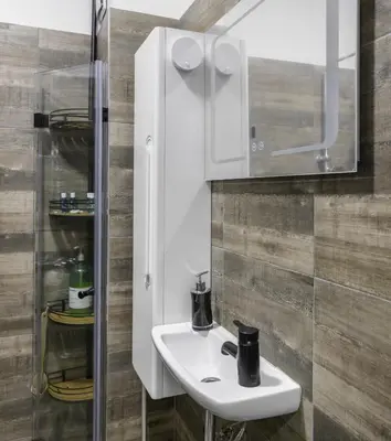 a bathroom with a white sink and a mirror at Cozy 1BD Flat Close to the City Center by Flat Mаnager in Sofia