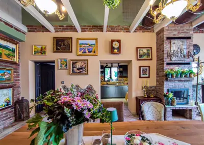 a living room with a table with flowers on it at Къща за гости Casa La Tinozza in Hisarya