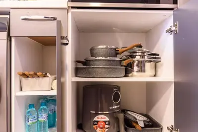 a kitchen cabinet with a coffee maker and other kitchen items at 2BR Apartment Near Gondola by SI Stay in Bansko