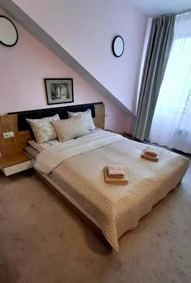 a bedroom with a large bed with two towels on it at 2BR Apartment Near Gondola by SI Stay in Bansko