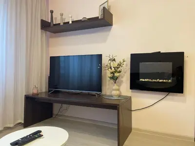a television sitting on a desk with a remote control at 2BR Apartment Near Gondola by SI Stay in Bansko