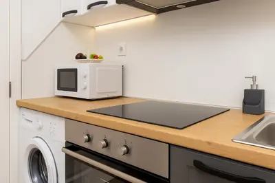 a kitchen with a counter top with a microwave at Cozy and comfortable northern apartment, Kapana district, Plovdiv, Center in Plovdiv