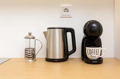 a coffeemaker and a coffee maker sitting on a table at Cozy and comfortable northern apartment, Kapana district, Plovdiv, Center in Plovdiv