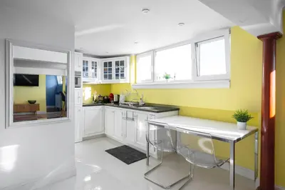 a kitchen with yellow walls and white cabinets at Best Views from Top Central Cozy 1-Bedroom Flat by Flat Mаnager in Sofia